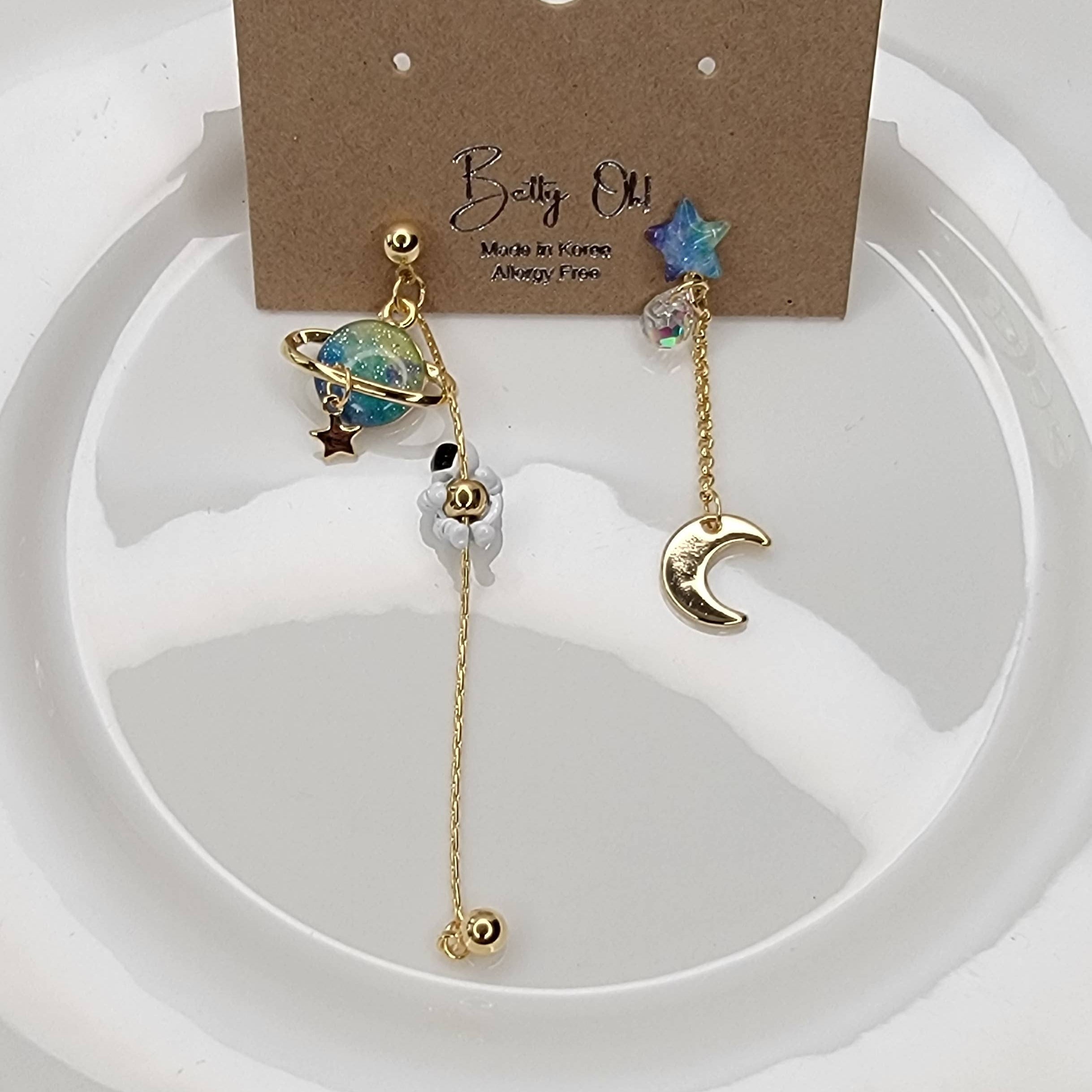 ASTRONAUT EARTH MOON AND STAR UNBALANCED DANGLE EARRINGS.