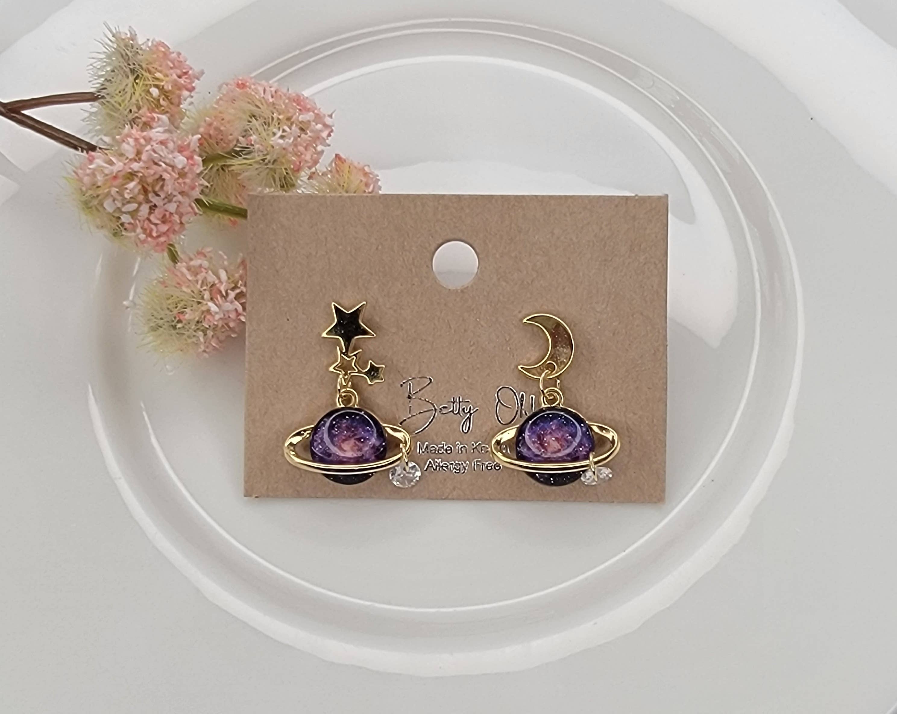 PLANET AND STAR AND MOON DANGLE EARRINGS.